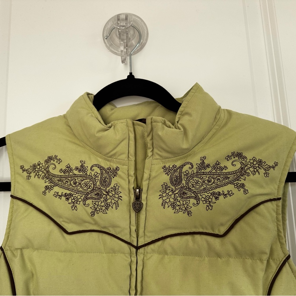 Ariat down vest light green with brown stitching and piping.